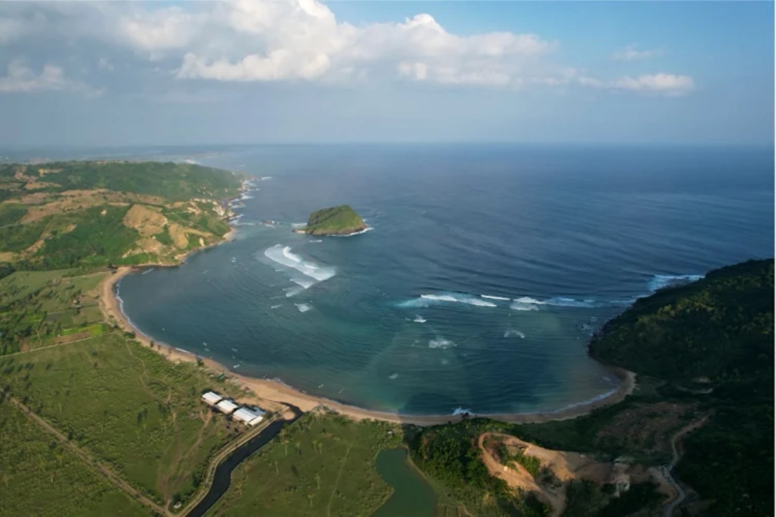 Aerial view of Are Guling Bay, its reef lines and surrounding hills