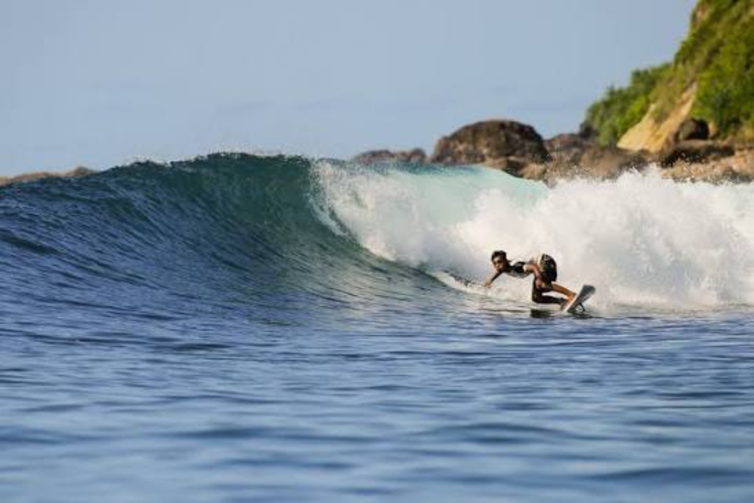 Surfer drawing a line across a clean Are Guling wave